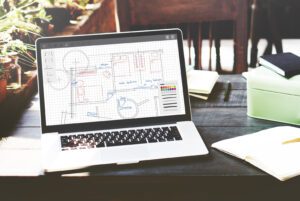 Construction project leads and building plans on a laptop for California contractors